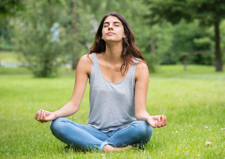 Woman Doing Meditation In Park